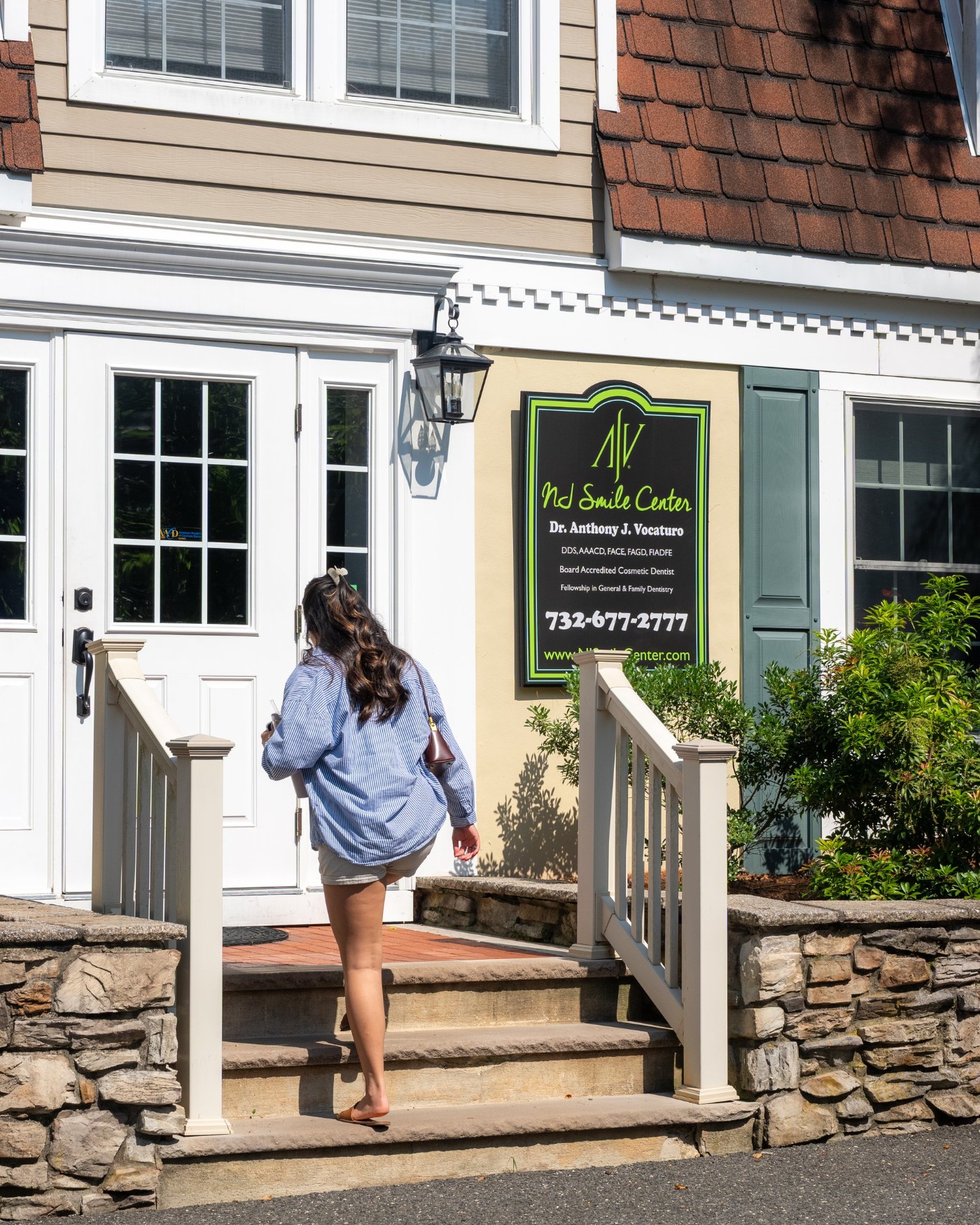 Patient walking up the steps of NJ Smile Center in Colts Neck